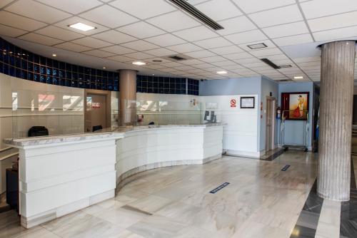 a large lobby with a bar in a building at Hotel Palacio del Mar in Santander