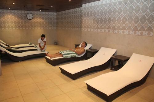 two people laying in beds in a room at Islamabad Serena Hotel in Islamabad