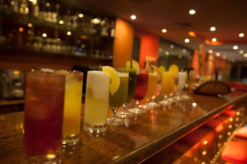 a row of wine glasses sitting on a bar at Islamabad Serena Hotel in Islamabad