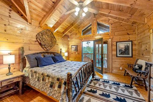 a bedroom with a bed in a room with wooden walls at Bear Tracks in Pigeon Forge