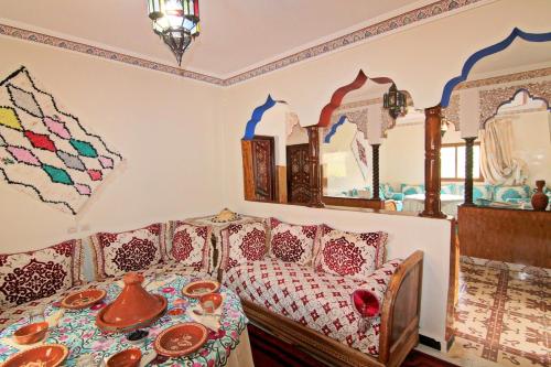 a bedroom with a bed and a table with dishes on it at Jnane Karma in Imlil