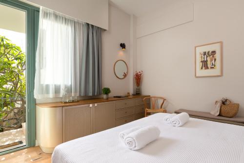 a bedroom with two white towels on two beds at Casa Natura in Rhodes Town