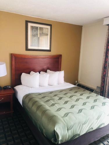 a large bed in a hotel room with at Quail Inn and Suites - Myrtle Beach in Myrtle Beach
