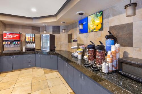 a restaurant kitchen with a counter with drinks on it at Comfort Suites Denver Tech Center in Centennial