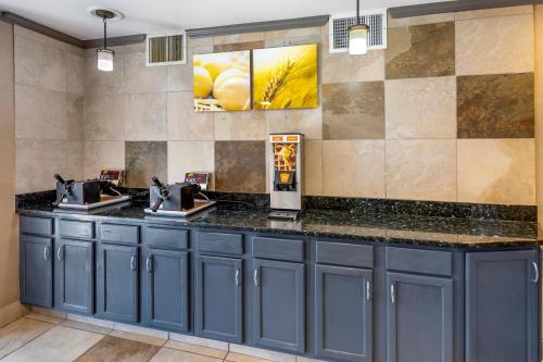 a bar in a restaurant with blue cabinets at Comfort Suites Denver Tech Center in Centennial
