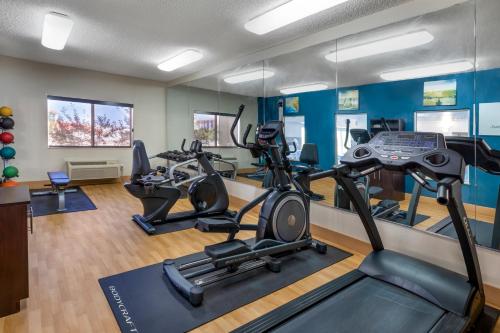 a gym with three treadmills and cardio machines at Comfort Suites Denver Tech Center in Centennial