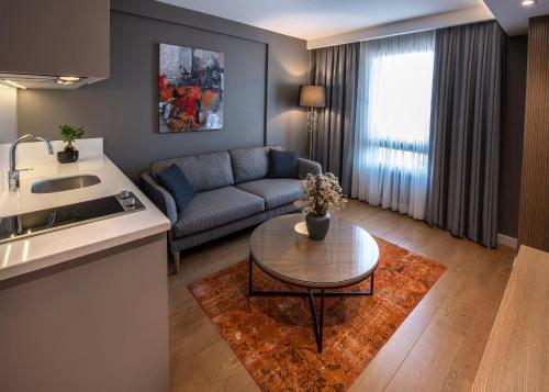 a living room with a couch and a table at Valente Suites&Hotel in Istanbul