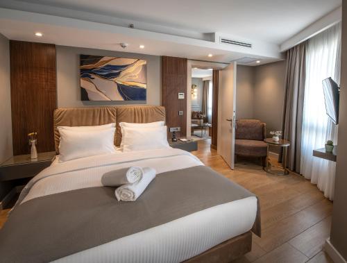 a bedroom with a large bed with towels on it at Valente Suites&Hotel in Istanbul