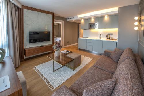 a living room with a couch and a table at Valente Suites&Hotel in Istanbul