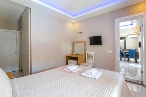 a bedroom with a bed with two towels on it at Nur Suites & Hotels in Kalkan