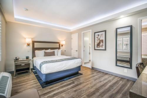a hotel room with a bed and a desk at Inn at 50 Long Beach Convention Center in Long Beach