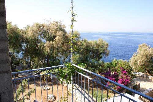 a balcony with a view of the ocean at Katafigio Village in Kotrónion