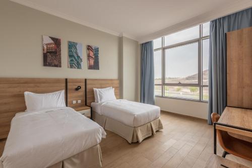 Ένα ή περισσότερα κρεβάτια σε δωμάτιο στο Hasanah suites