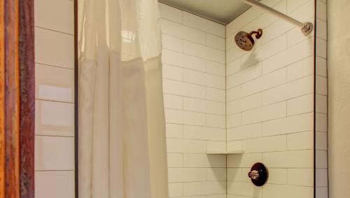 a bathroom with a shower stall and a toilet at The Bristol Hotel in Steamboat Springs