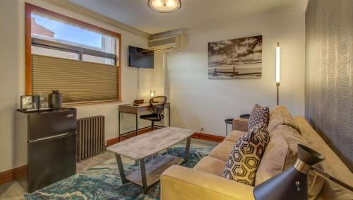 a living room with a couch and a table at The Bristol Hotel in Steamboat Springs