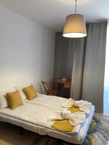 a bedroom with a bed and a table and a lamp at Mirabell Studio Bansko - Amazing view & fireplace in Bansko