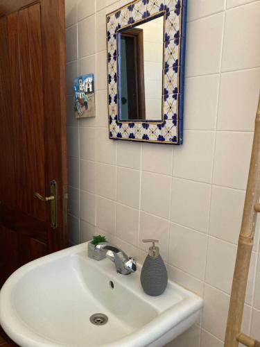 a bathroom with a sink and a mirror at Monte da Fonte - piscina, tenis e snooker no Alentejo in Vila de Frades
