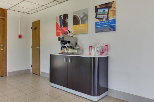 a kitchen with a counter with a coffee maker at Wingate by Wyndham Geneva at SPIRE Academy in Geneva