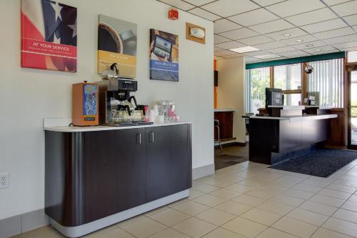 a waiting room with a counter in a pharmacy at Wingate by Wyndham Geneva at SPIRE Academy in Geneva