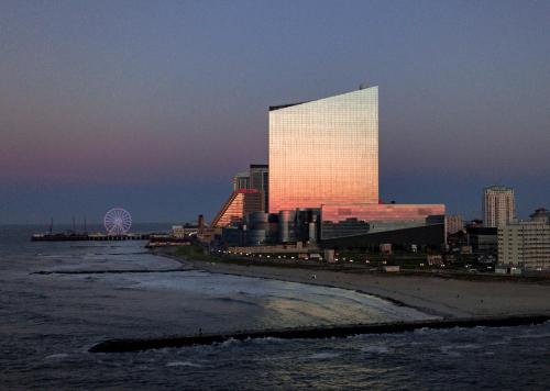 a tall building is lit up in the sunset at Ocean Casino Resort in Atlantic City