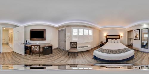a hotel room with a large bed and a desk at Inn at 50 Long Beach Convention Center in Long Beach