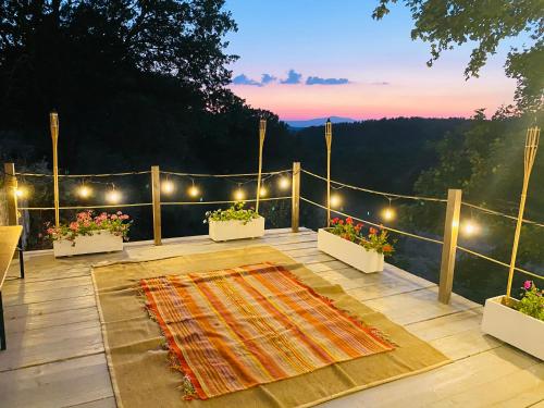 a patio with a rug on a deck with lights at Villa Edera in San Venanzo