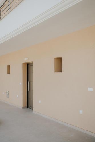 a room with a white wall and a door at elia boutique hotel in Parga