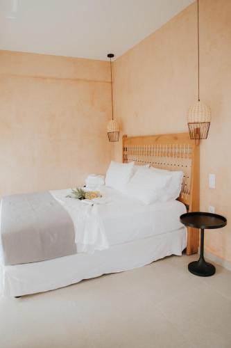 a bedroom with a white bed and a table at elia boutique hotel in Parga
