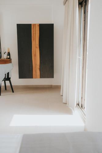 a white room with a window and a table at elia boutique hotel in Parga