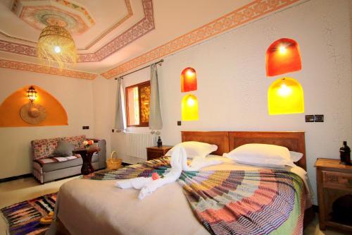 a bedroom with a bed with a stuffed animal on it at Jnane Karma in Imlil