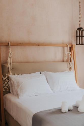 a bed with white sheets and pillows in a room at elia boutique hotel in Parga