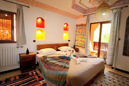 a bedroom with a bed with a flower on it at Jnane Karma in Imlil