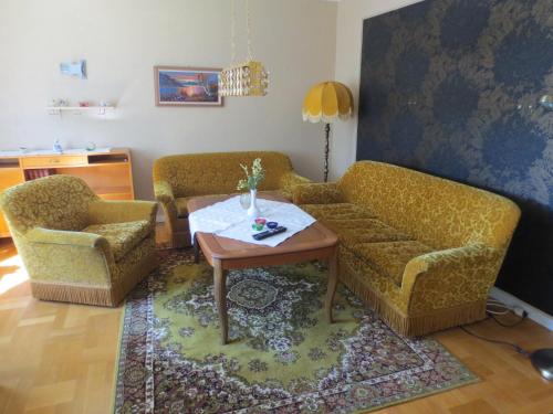a living room with two couches and a table at Joastorps Bed & Breakfast in Ullared