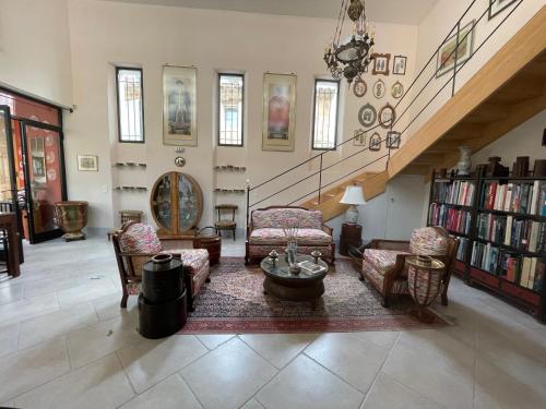 a living room filled with furniture and a staircase at La Cour Carrée in Rustrel