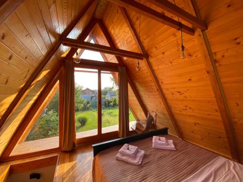 a bedroom in a tree house with a large window at Petrovaradin Chalet in Novi Sad