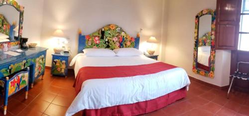 a bedroom with a large bed in a room at Hotel Hacienda Don Cenobio in San Pablo Villa de Mitla