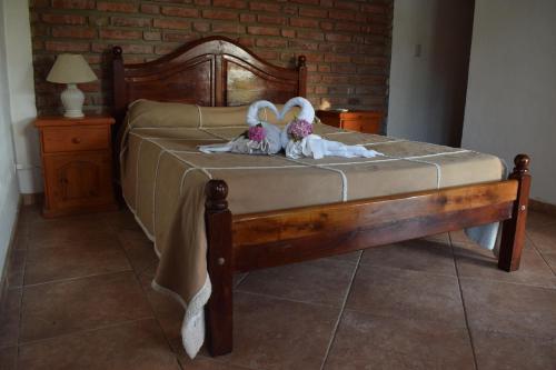 two stuffed animals are laying on a bed at Estancia Santa Leocadia in Bialet Massé