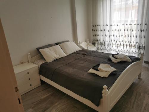 a bedroom with a bed and a dresser and a window at Entire Bedroom Apartment with big Balcony Perfect for Families Mishev in Nea Moudania