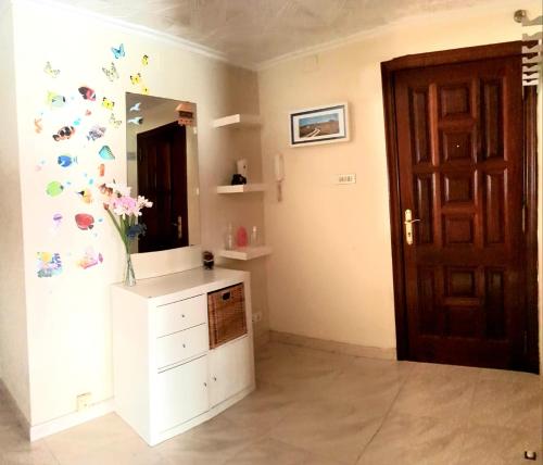 a bathroom with a mirror with butterflies on the wall at Piso in Cedeira