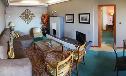 a living room with a couch and a table at Hotel Ciudad de Vigo in Vigo