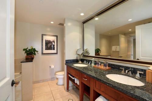 a bathroom with two sinks and a large mirror at Large 1BR Luxury Condo at Honua Kai w/Huge Lanai K224 in Lahaina