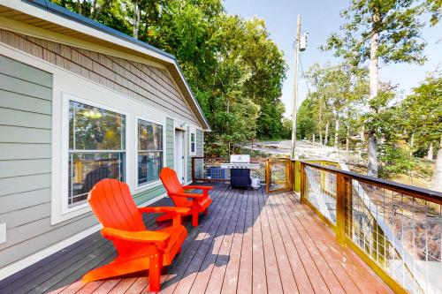 two orange chairs sitting on a porch of a house at Koeve's Cove in Dandridge