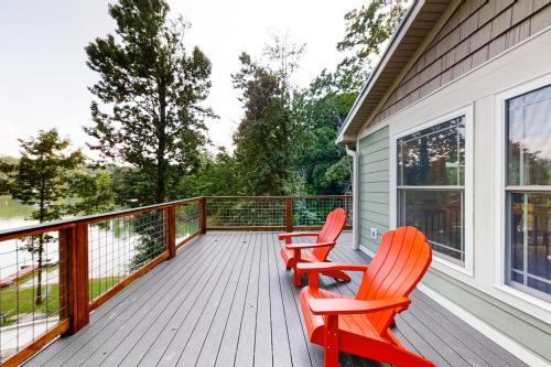 two red chairs sitting on a deck on a house at Koeve's Cove in Dandridge