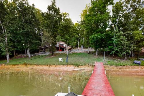 a red dock in the middle of a body of water at Koeve's Cove in Dandridge