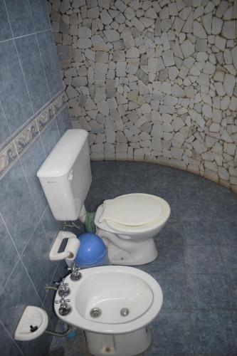 a bathroom with a toilet and a sink at Estancia Santa Leocadia in Bialet Massé