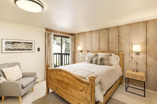 a bedroom with a bed and a chair and a window at 60 Fall Lane Sonnenblick #3 Townhouse in Snowmass Village