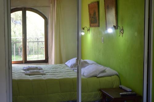 a bedroom with a bed and a window at Estancia Santa Leocadia in Bialet Massé
