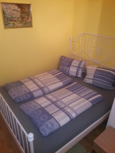 a bedroom with a bed with purple and white sheets at Ferienwohnung Familie Tost in Trins