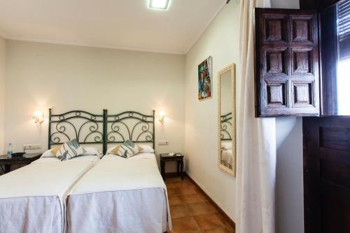 Ένα ή περισσότερα κρεβάτια σε δωμάτιο στο Hotel Palacio del Intendente
