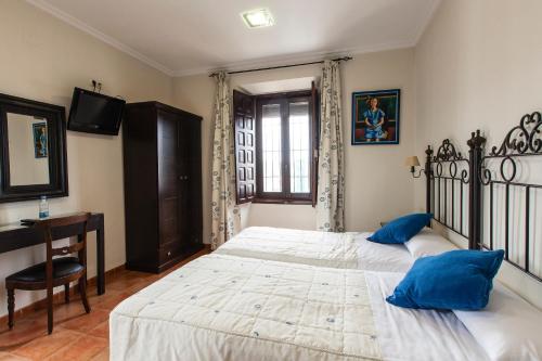 Ένα ή περισσότερα κρεβάτια σε δωμάτιο στο Hotel Palacio del Intendente